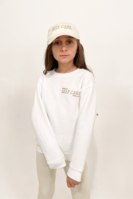mini self care white crew neck sweater